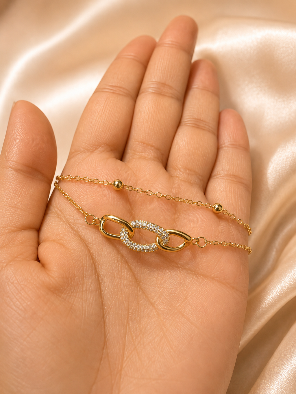 Interlink Dual Chain Bracelet by Ashaarya featuring a crystal-studded interlocking link in 18KT gold plated 316L stainless steel. Lightweight, anti-tarnish bracelet for women.