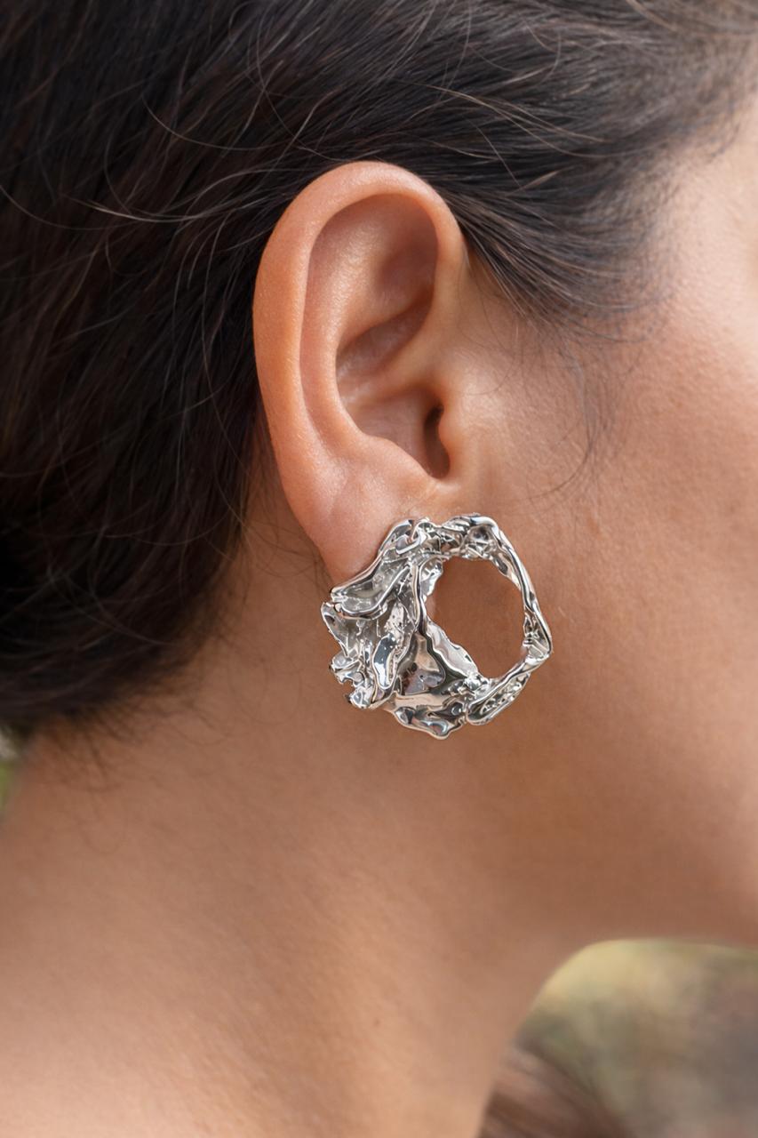 Anti-Tarnish, Ashaarya, Ashaarya Jewels, Ashaarya Jewellery, Close-up of a person wearing a silver hoop earring with a textured design.