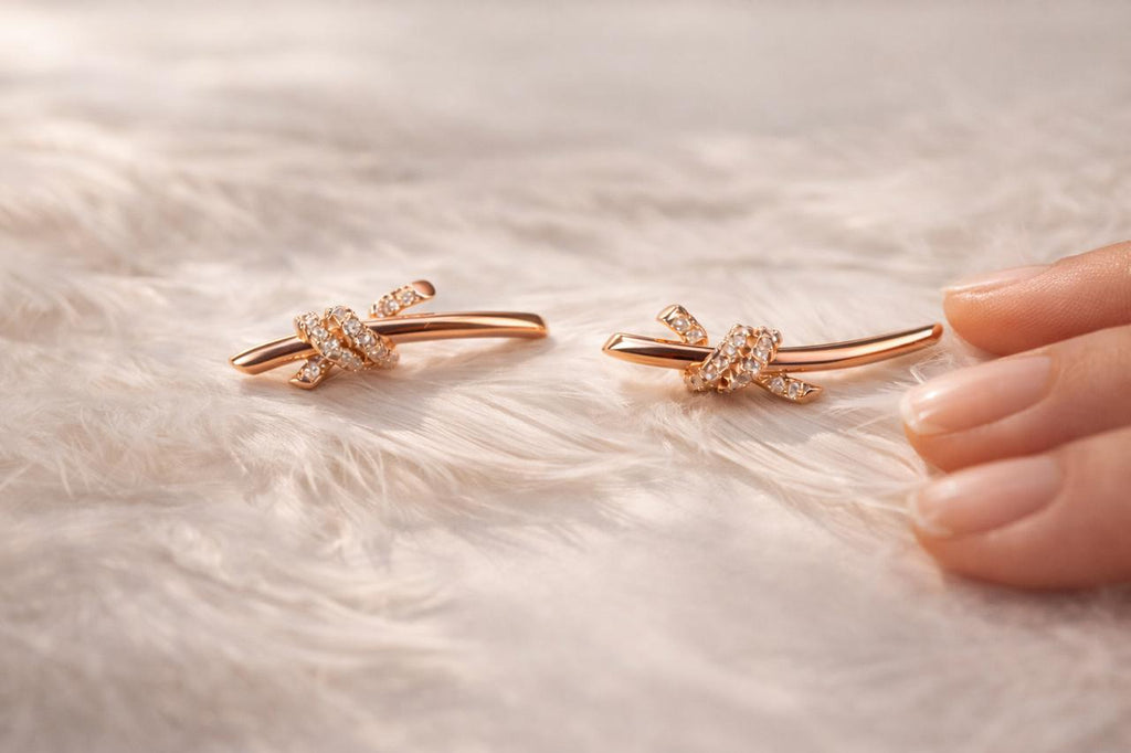 Anti-Tarnish, Ashaarya, Ashaarya Jewels, Ashaarya Jewellery, Rose gold bow-shaped earrings on a soft fabric background