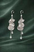 Anti-Tarnish, Ashaarya, Ashaarya Jewels, Ashaarya Jewellery,Pair of silver earrings with clear gemstones on a green fabric background