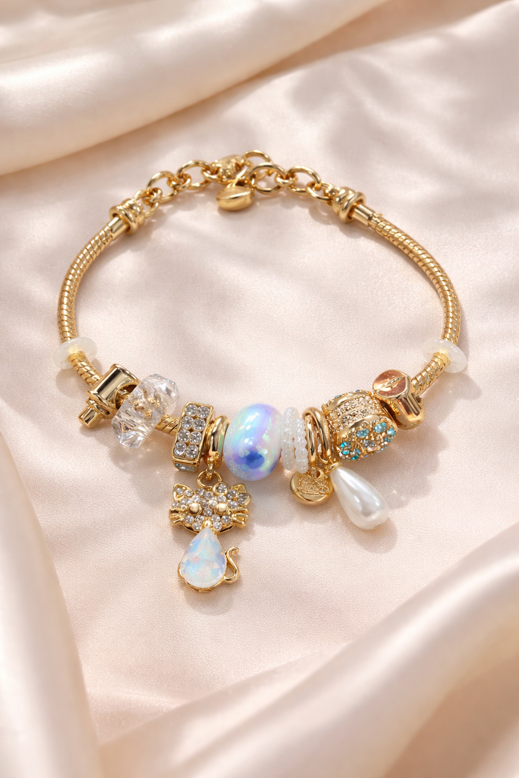 Anti-Tarnish, Ashaarya, Ashaarya Jewels, Ashaarya Jewellery,Gold bracelet with various charms on a soft beige background