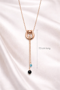 Rose gold necklace with pendant on a satin background, showing length measurement.