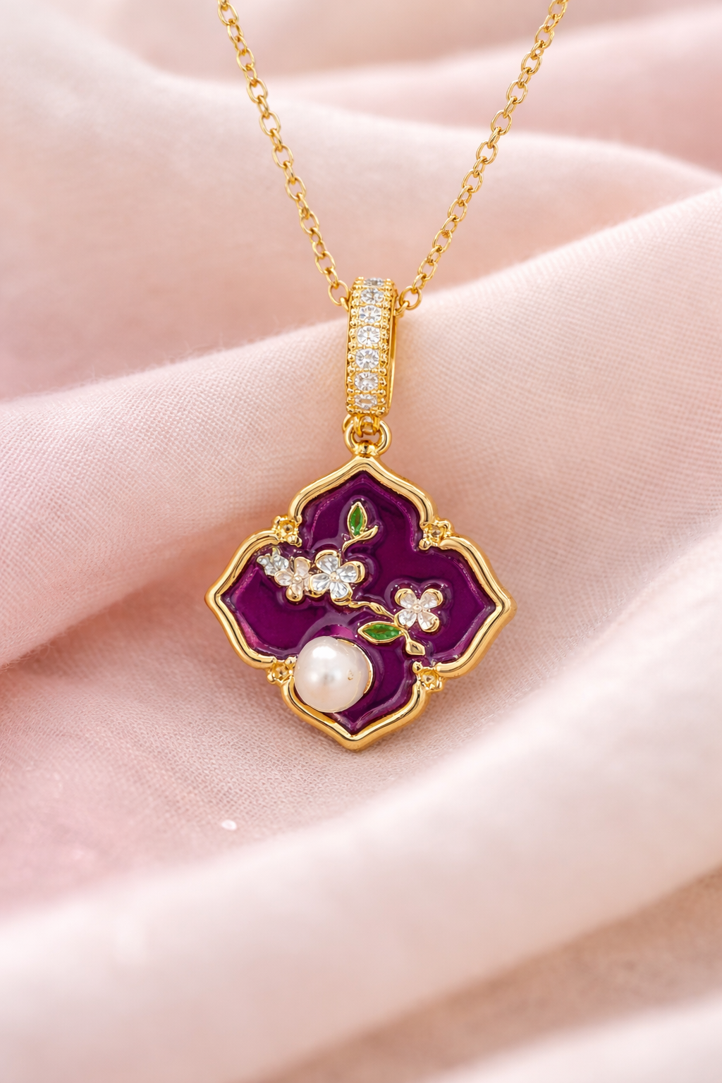 Anti-Tarnish, Ashaarya, Ashaarya Jewels, Ashaarya Jewellery, Gold necklace with a purple pendant featuring a pearl and floral design on a pink fabric background.