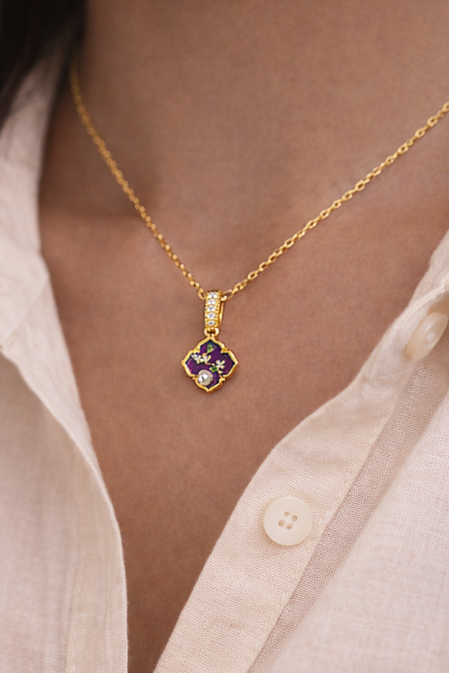 Anti-Tarnish, Ashaarya, Ashaarya Jewels, Ashaarya Jewellery, Gold necklace with a purple gemstone pendant worn by a person in a light-colored shirt.
