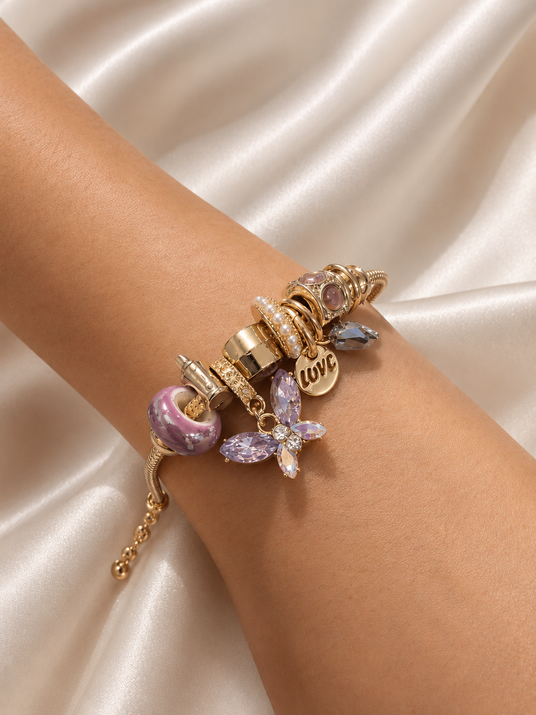charm bracelet, gold tone charm bracelet, butterfly charm bracelet, lavender charm bracelet, purple charm bracelet, charm bracelet for women, anti tarnish jewellery, 316L stainless steel jewellery, lightweight bracelet, skin friendly jewellery, demi fine jewellery, everyday bracelet, comfort jewellery, adjustable bracelet, Ashaarya charm bracelet