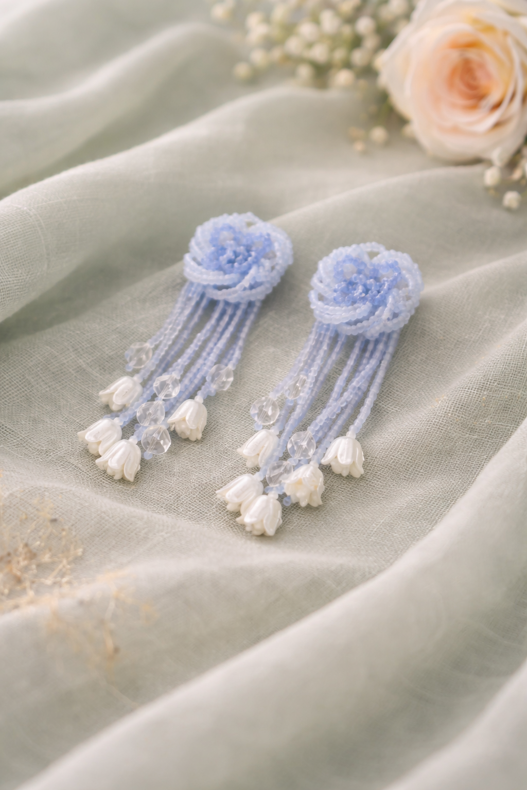 Anti-Tarnish, Ashaarya, Ashaarya Jewels, Ashaarya Jewellery, Pair of blue floral earrings on a light fabric background