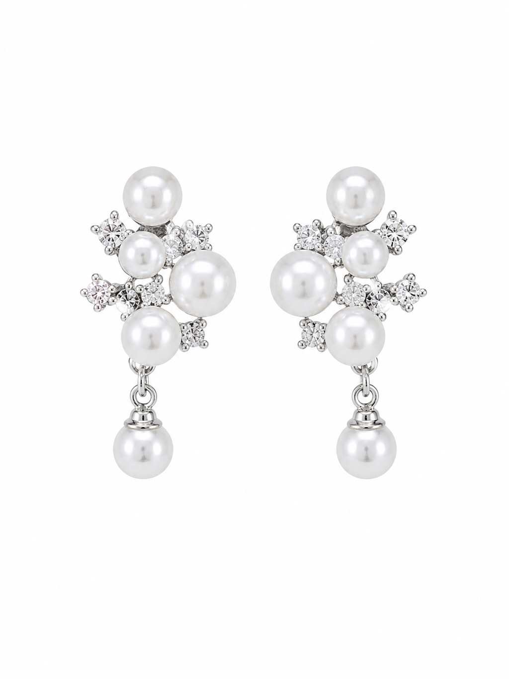 A pair of silver-toned drop earrings featuring white freshwater pearls and small clear cubic zirconia accents, displayed against a solid white background.  Anti-tarnish clip-on pearl earrings with crystal detailing by Ashaarya