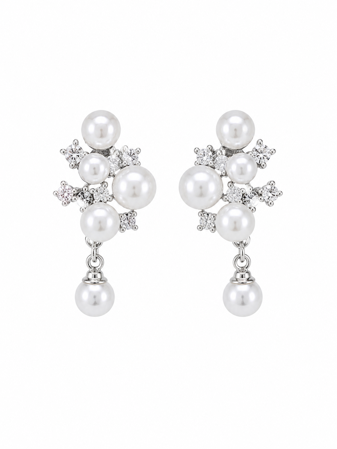 A pair of silver-toned drop earrings featuring white freshwater pearls and small clear cubic zirconia accents, displayed against a solid white background.  Anti-tarnish clip-on pearl earrings with crystal detailing by Ashaarya