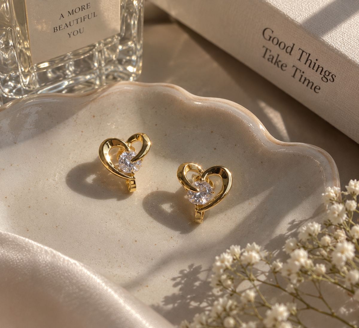 Anti-tarnish comfort clip-on earrings in polished gold with heart-shaped detailing and a sparkling centre crystal, ideal for everyday styling