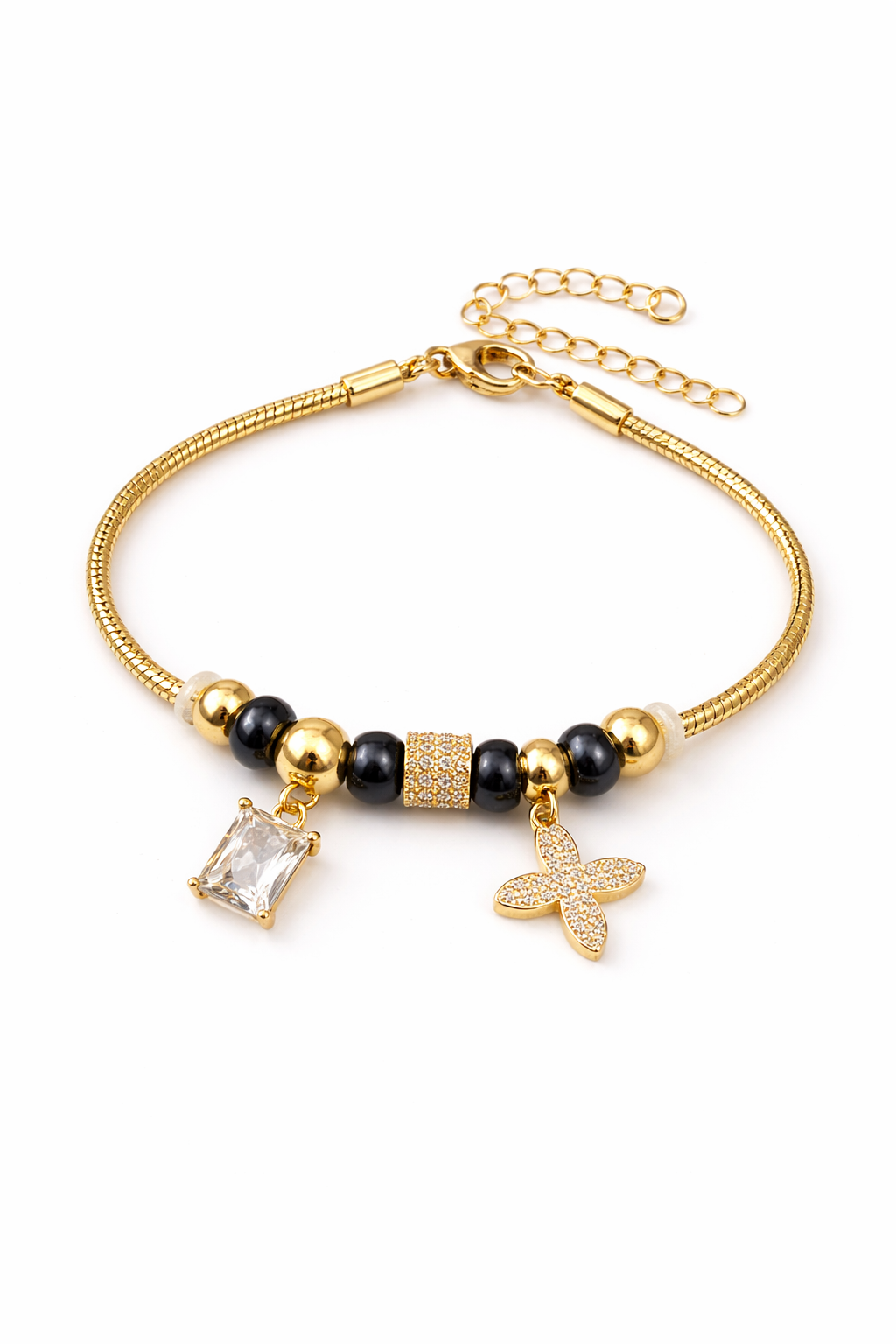 Anti-tarnish comfort jewellery charm bracelet for women with American diamond charms, gold tone beads and black stone beads – Ashaarya demi-fine charm bracelet close-up showing emerald cut stone charm and floral diamond charm