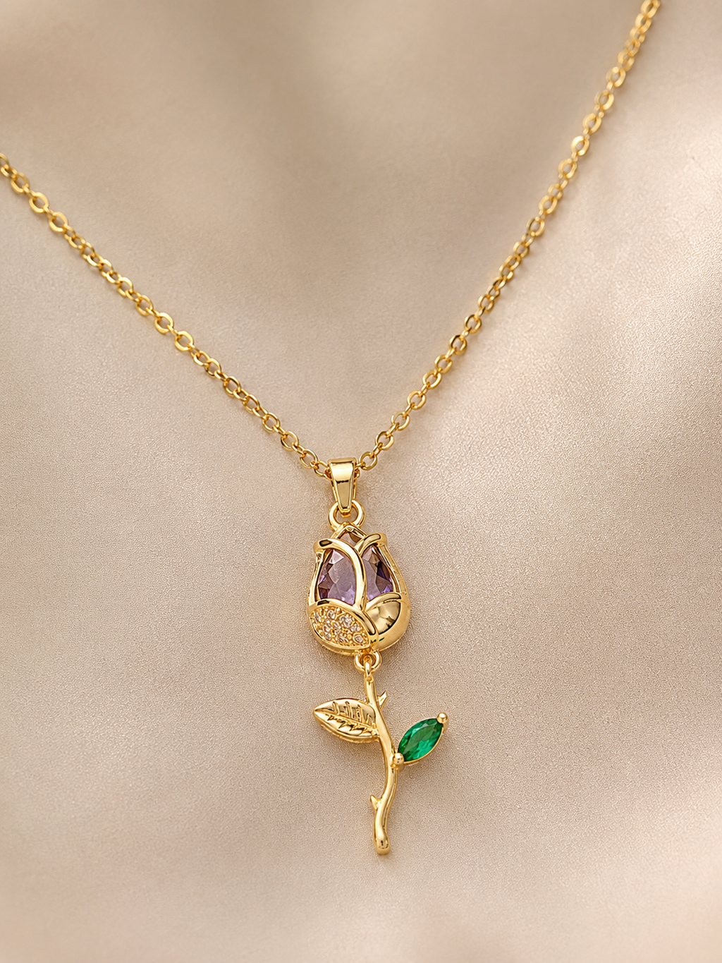 Anti-tarnish demi-fine necklace for women featuring a purple gemstone, green leaf detail and delicate gold-tone chain for everyday wear