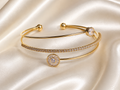 Anti-tarnish gold layered bracelet for women with delicate crystal detailing and a minimalist open cuff design