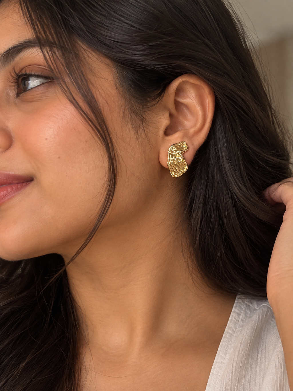 Anti-tarnish gold statement clip-on earrings with an elegant sculpted silhouette and intricate detailing, designed for women who prefer non-pierced earrings
