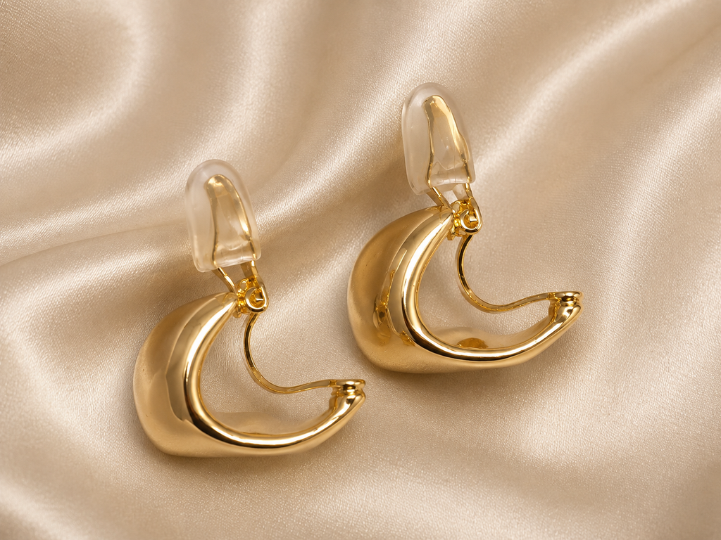Anti-tarnish gold statement clip-on earrings with a bold rounded silhouette and sleek polished finish for everyday styling