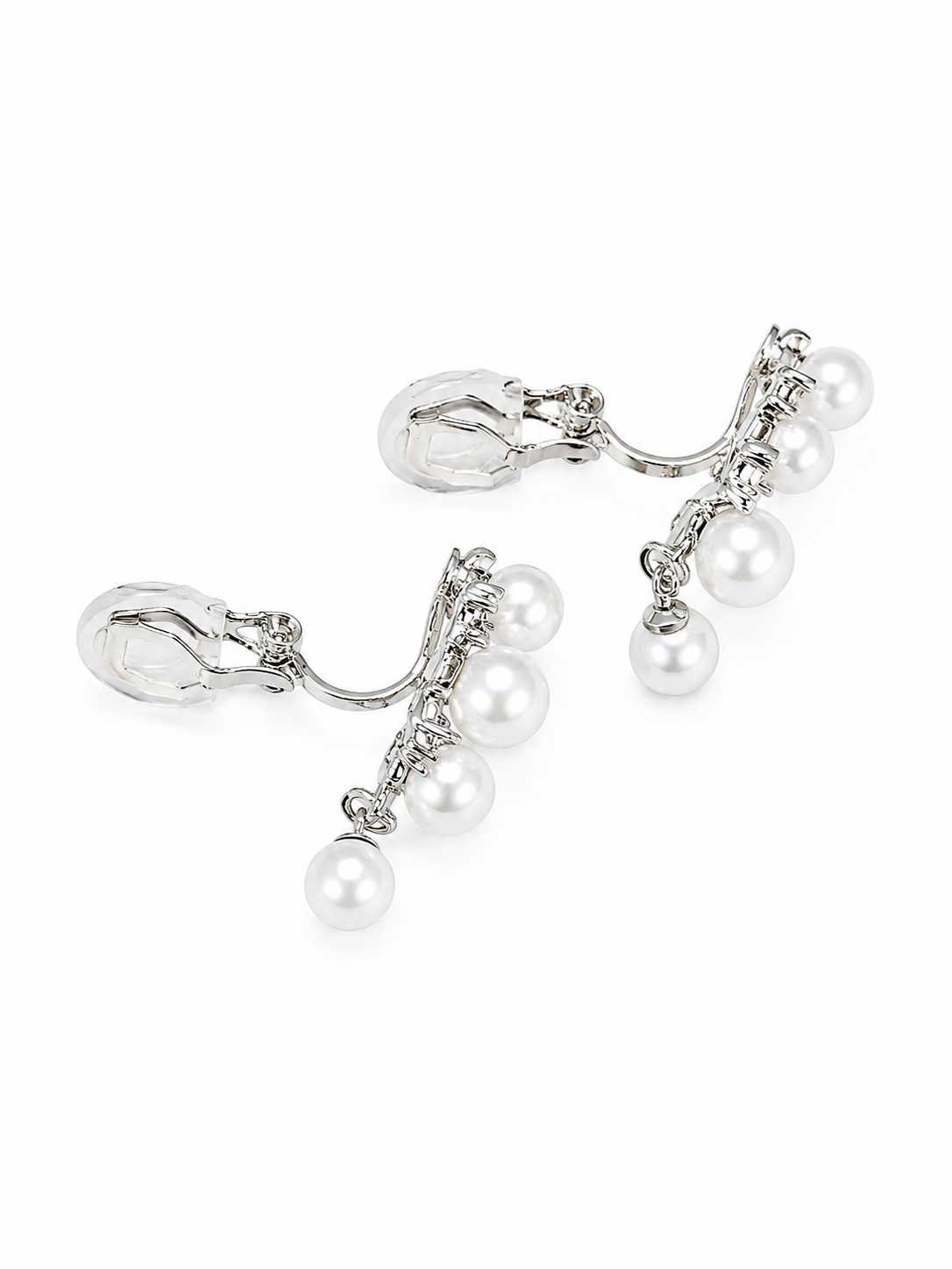 A pair of silver-toned clip-on earrings with dangling chains and white faux pearls, shown on a plain white background.