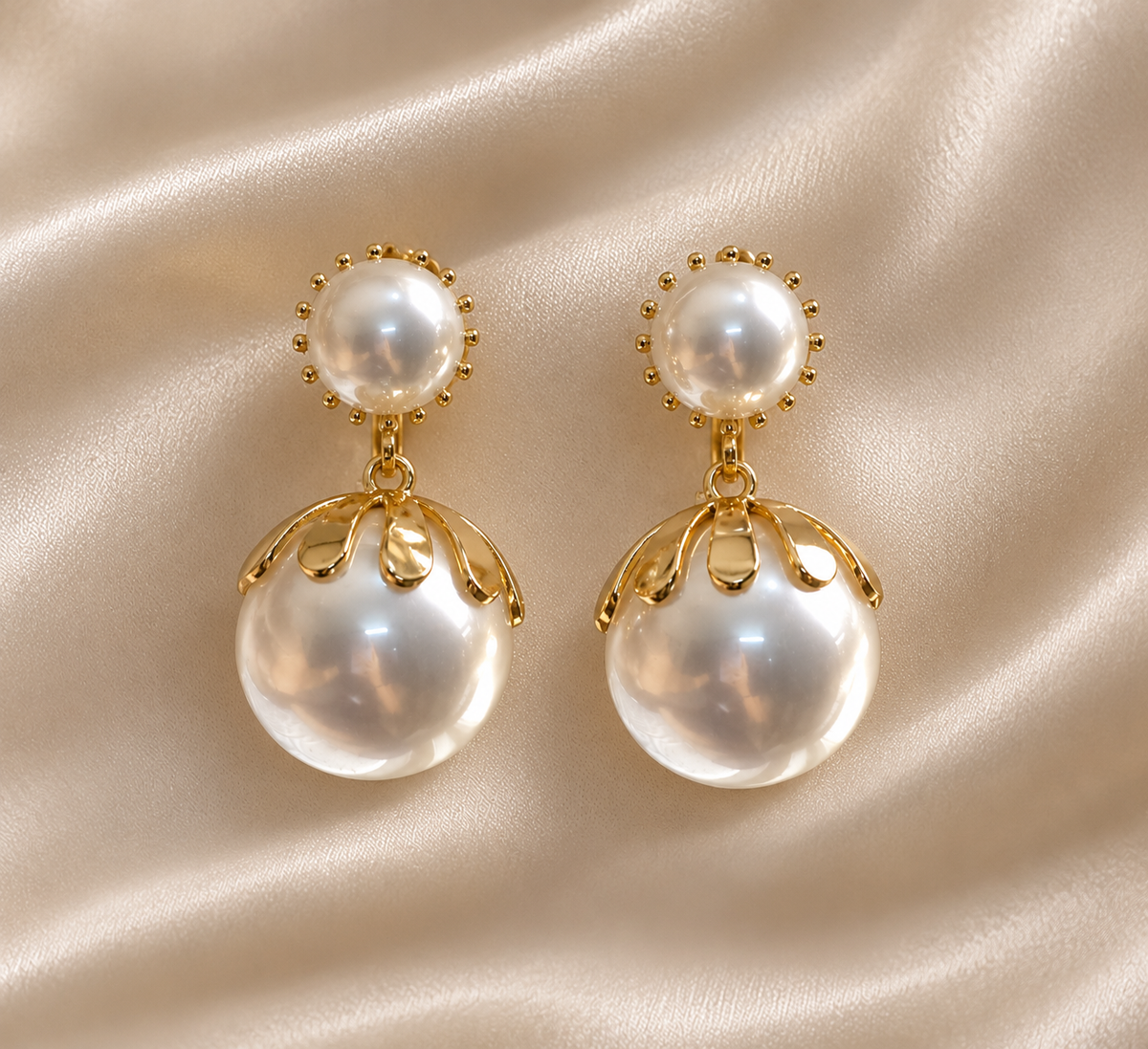 Anti-tarnish pearl drop clip-on earrings in gold tone featuring glossy white pearls and delicate petal detailing, designed for women with non-pierced ears