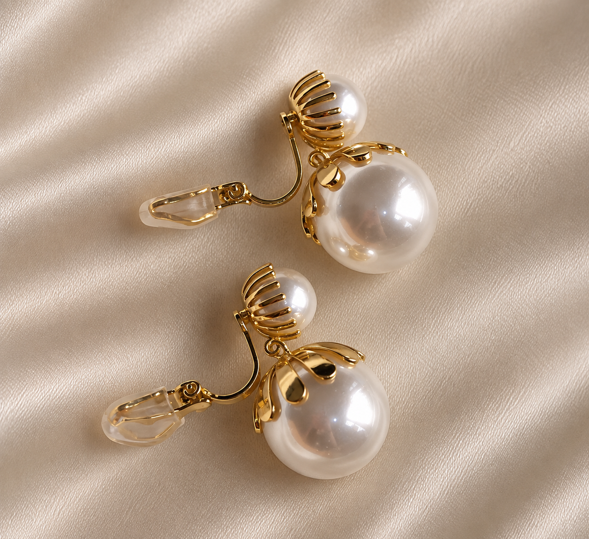 Anti-tarnish dangling clip-on earrings with white pearl drops and gold petal-inspired detailing, elegant comfort jewellery for women