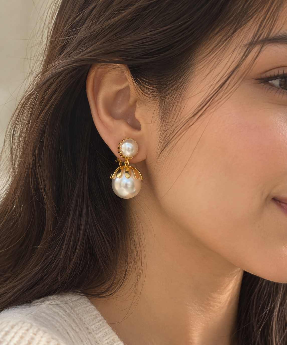 Anti-tarnish gold pearl clip-on earrings for non-pierced ears, featuring double pearl design, polished gold accents and a feminine statement silhouette
