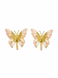 A pair of gold butterfly stud earrings with light pink enamel wings and white enamel accents, displayed on a clean white background. Anti-tarnish pink butterfly earrings for women