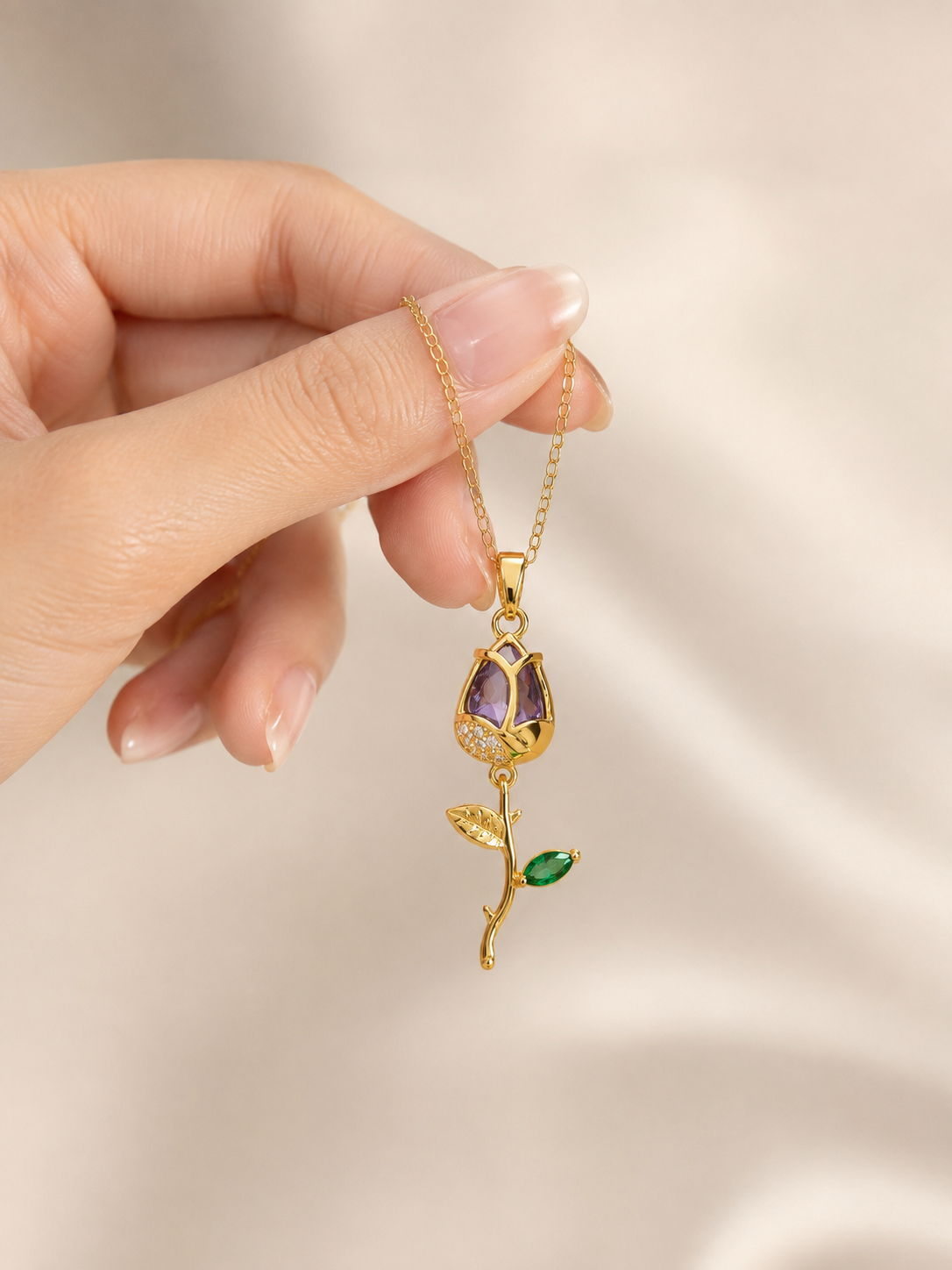 Anti-tarnish purple gemstone necklace with an elegant gold-tone chain and botanical-inspired pendant featuring purple and green stones