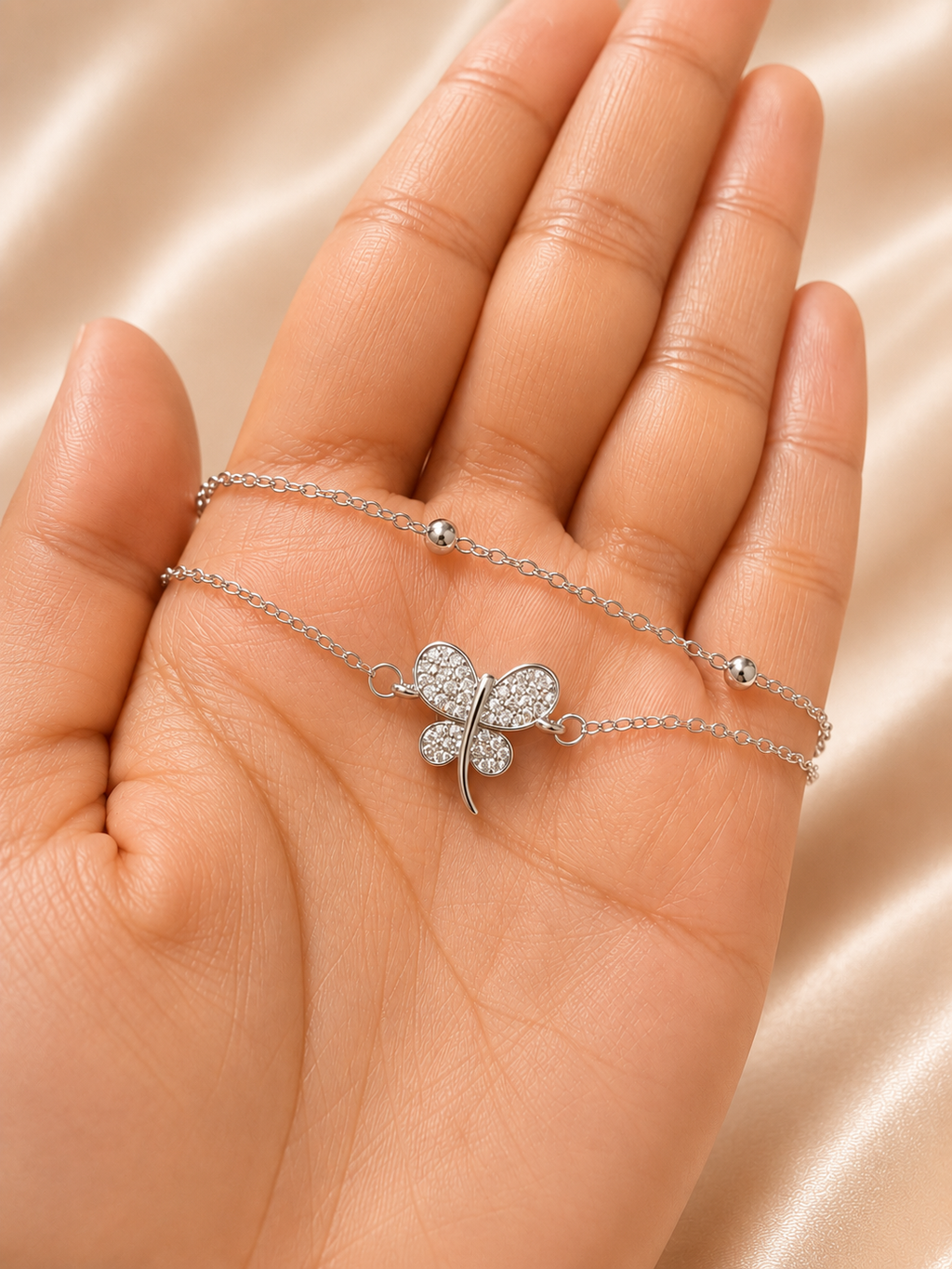 The Becoming Bracelet by Ashaarya featuring a sparkling silver butterfly charm on a dual-chain anti-tarnish 316L stainless steel bracelet for women.