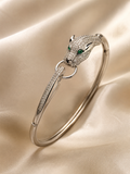 Anti-tarnish silver panther bracelet for women featuring a detailed panther head with sparkling stones and green gemstone eyes