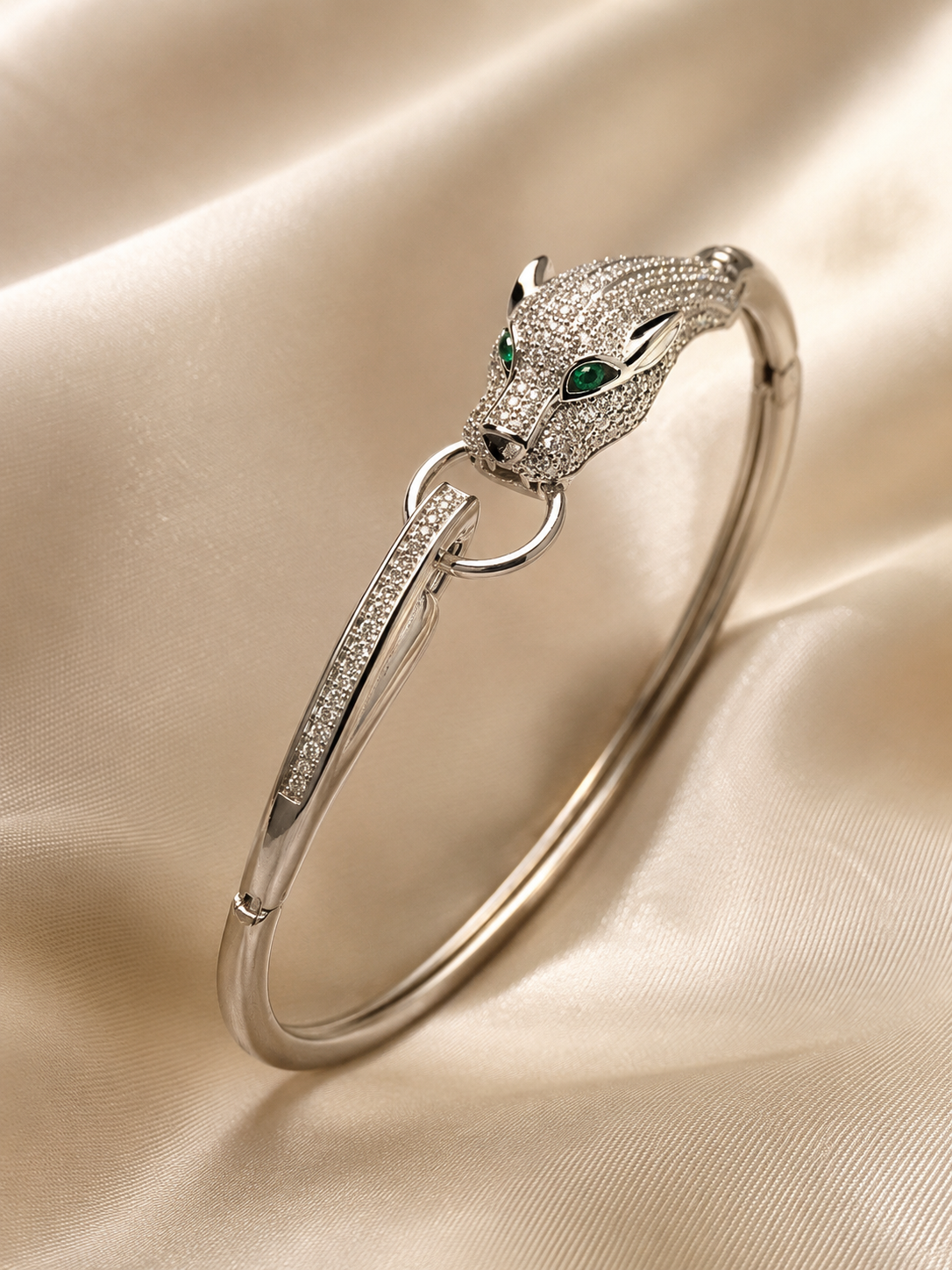 Anti-tarnish silver panther bracelet for women featuring a detailed panther head with sparkling stones and green gemstone eyes