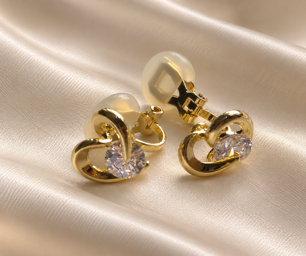 Anti-tarnish small gold heart earrings with clip-on fastening and clear gemstone detail, perfect for women without pierced ears