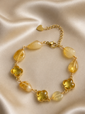 Anti-tarnish yellow natural stone bracelet for women featuring faceted yellow stones, clover-shaped crystal accents and gold-tone detailing