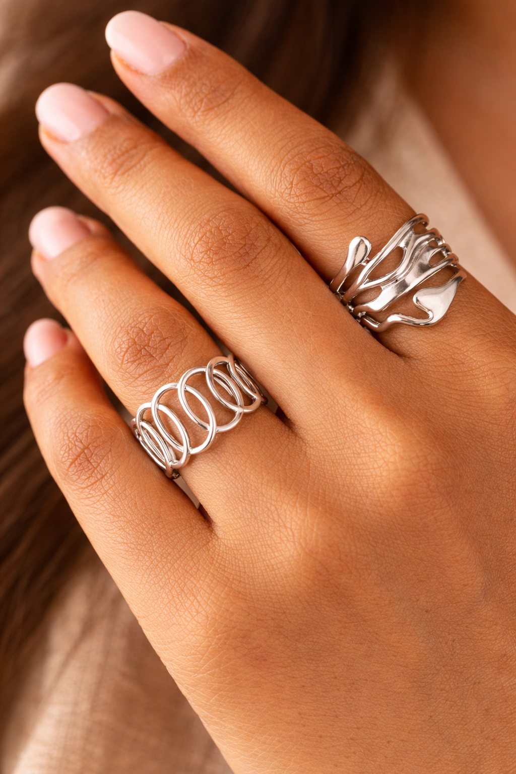 Anti-Tarnish, Ashaarya, Ashaarya Jewels, Ashaarya Jewellery, Hand wearing two silver rings with a blurred background