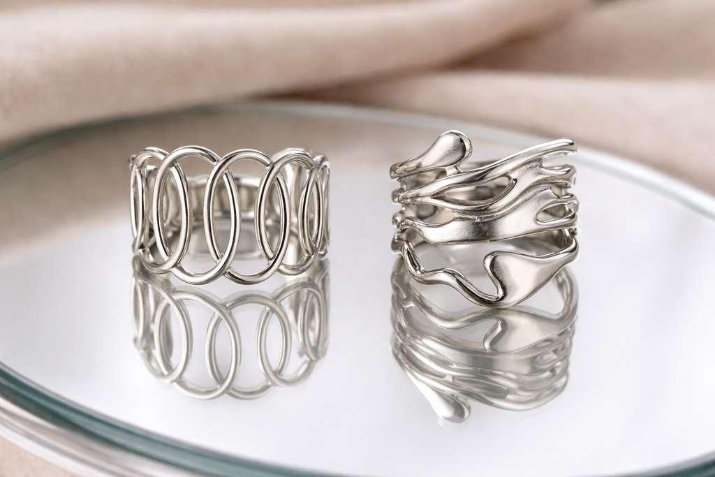 Anti-Tarnish, Ashaarya, Ashaarya Jewels, Ashaarya Jewellery, Two silver rings on a reflective surface with a neutral background