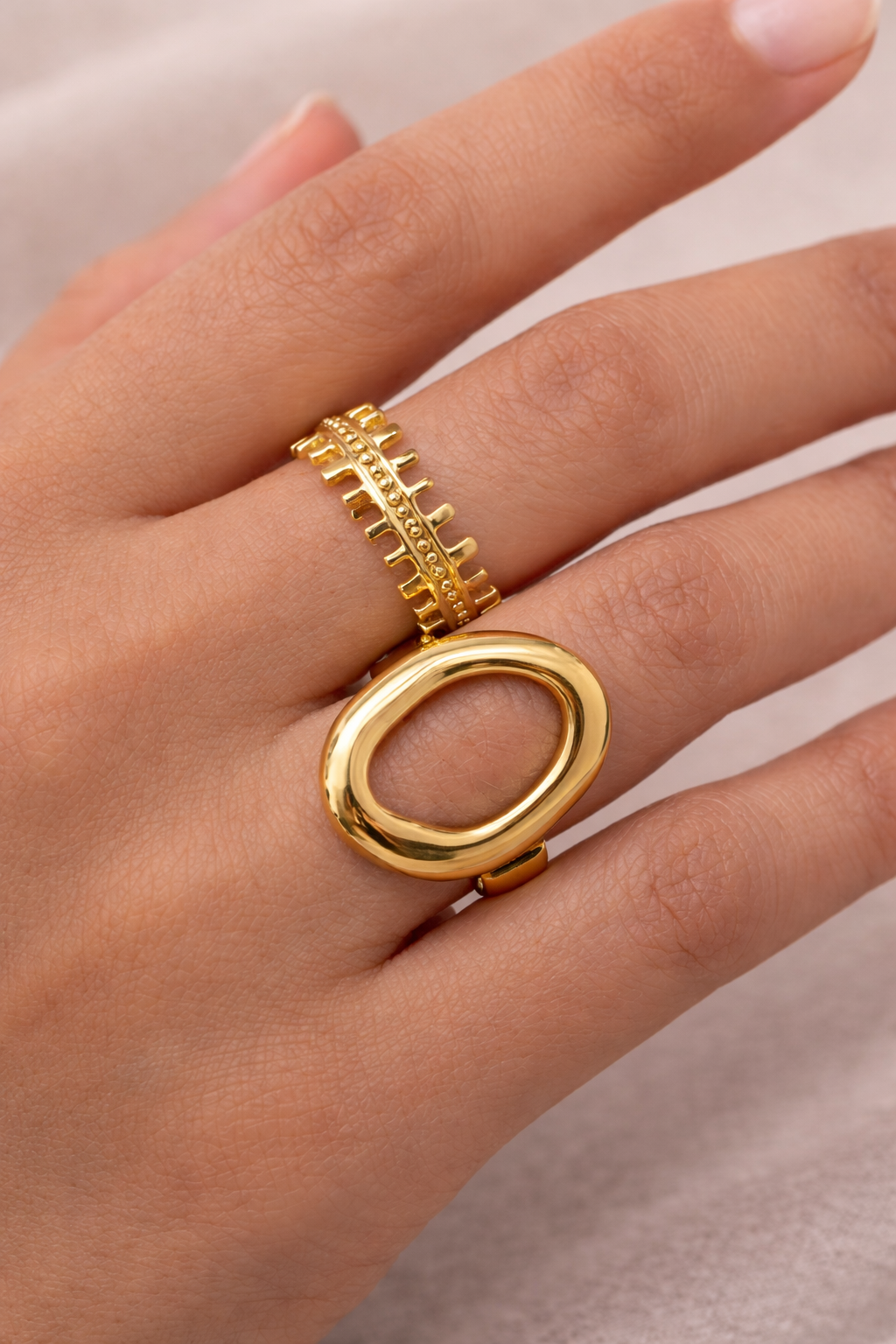 Anti-Tarnish, Ashaarya, Ashaarya Jewels, Ashaarya Jewellery, Gold ring on a person's finger against a neutral background