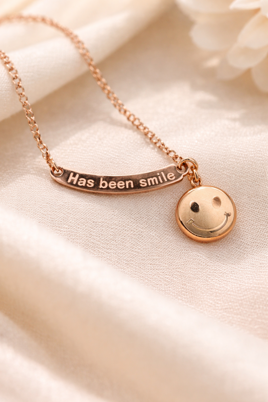 Anti-Tarnish, Ashaarya, Ashaarya Jewels, Ashaarya Jewellery, Rose gold necklace with a smiley face charm on a soft beige background