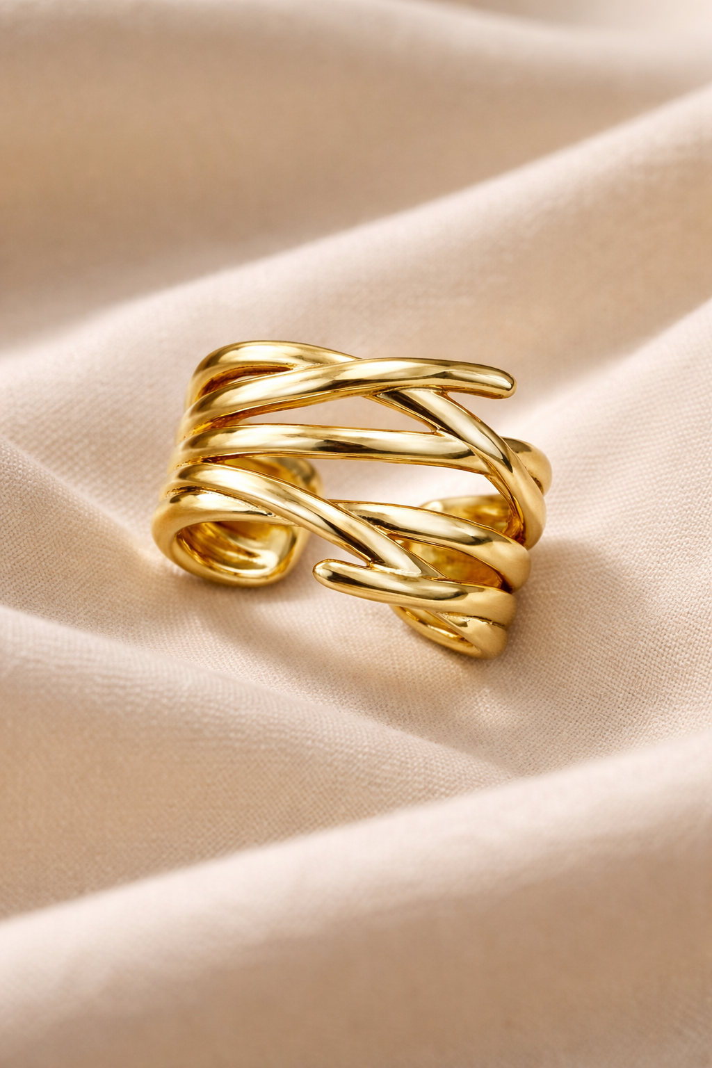 Anti-Tarnish, Ashaarya, Ashaarya Jewels, Ashaarya Jewellery, Gold ring with braided design on a beige fabric background