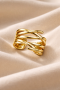 Anti-Tarnish, Ashaarya, Ashaarya Jewels, Ashaarya Jewellery, Gold ring with braided design on a beige fabric background