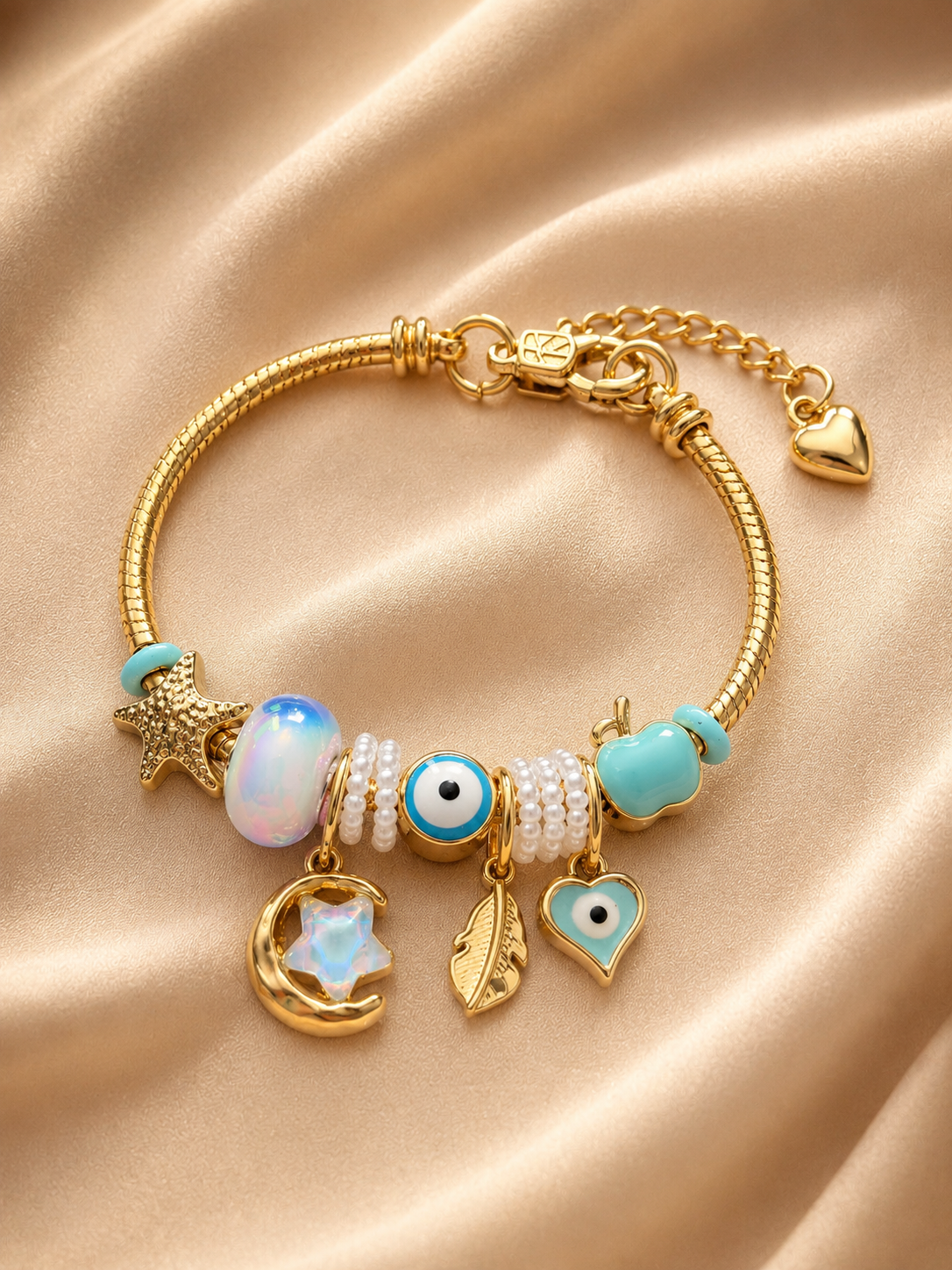Hand model wearing Chaand Nazar anti-tarnish charm bracelet with pastel celestial charms and gold-tone finish.