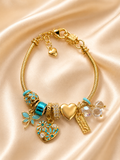 Neel Tara anti-tarnish turquoise and gold charm bracelet for women featuring crystal charms and heart detailing