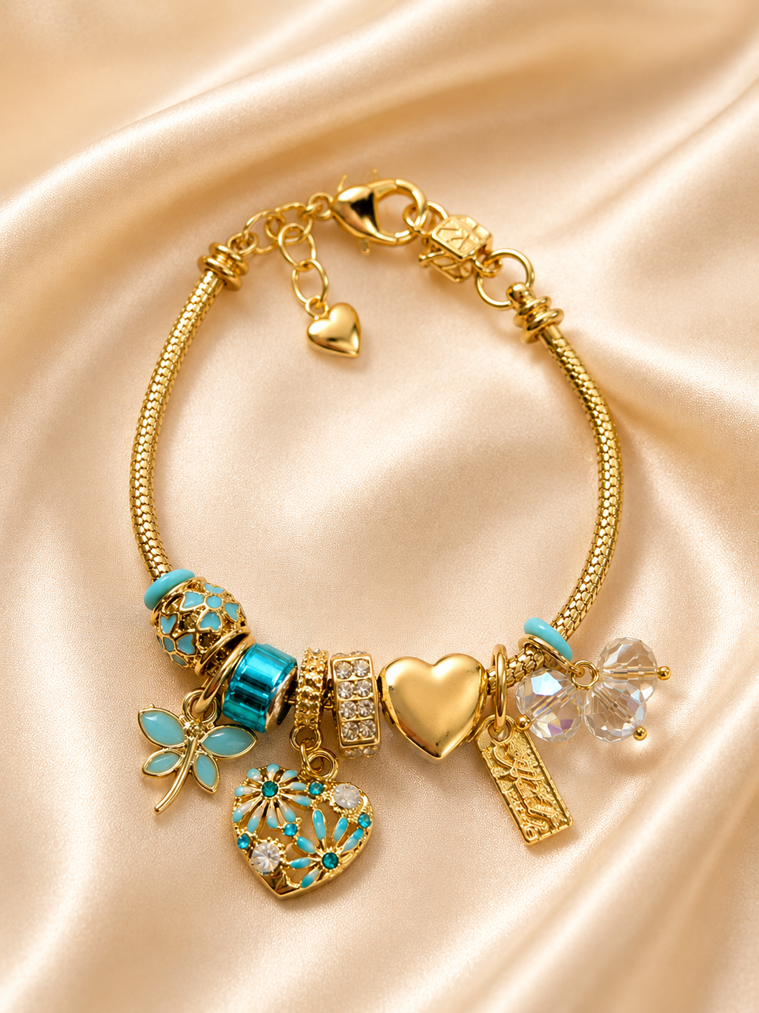 Neel Tara anti-tarnish turquoise and gold charm bracelet for women featuring crystal charms and heart detailing