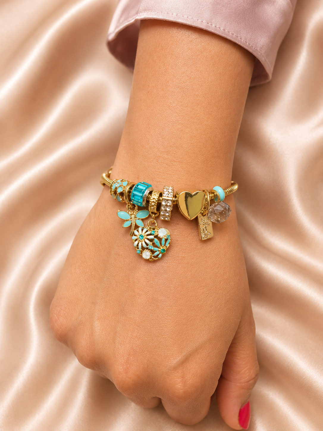Gold heart charm detail on anti-tarnish Neel Tara bracelet for women with turquoise decorative charms