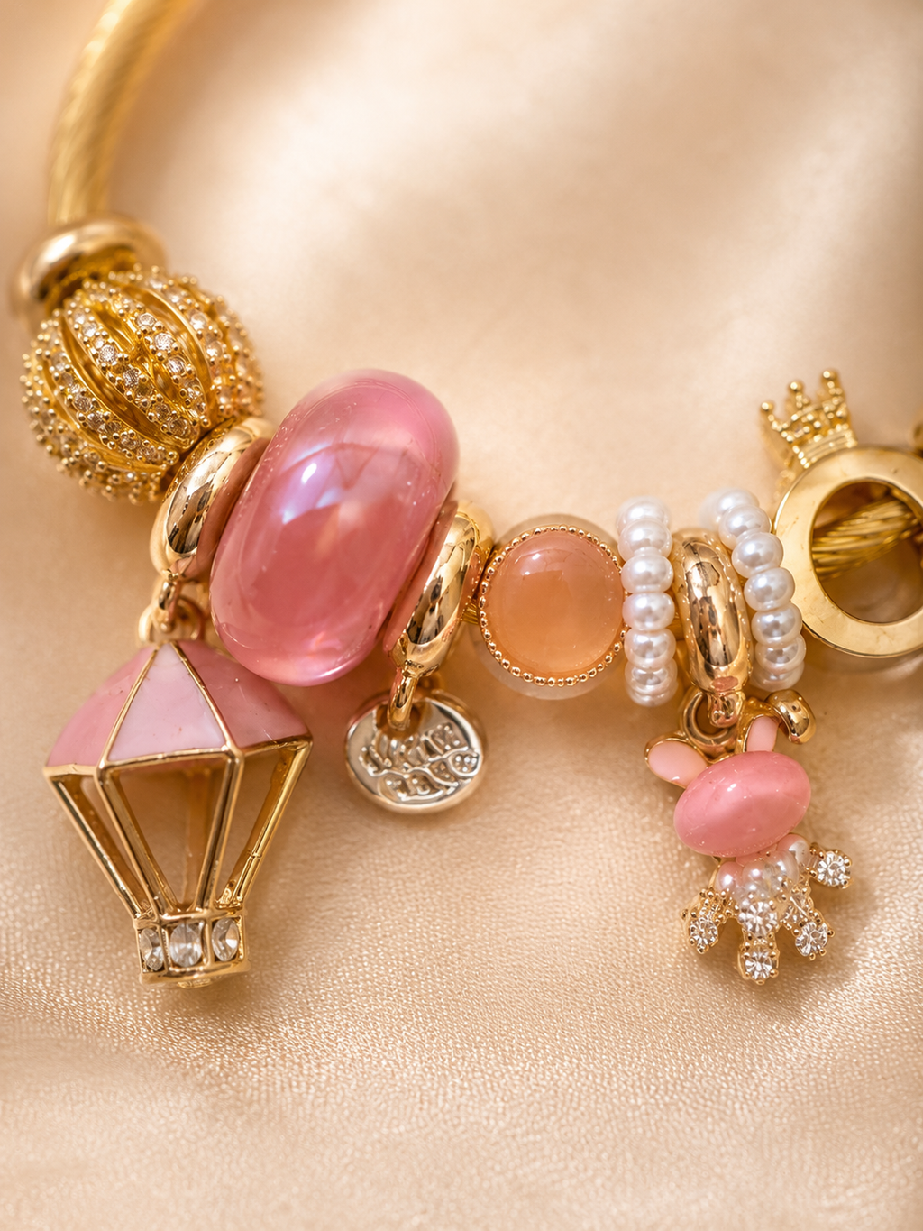 Detailed view of balloon charm, blush pink beads and pearl accents on Pink Postcards bracelet for women