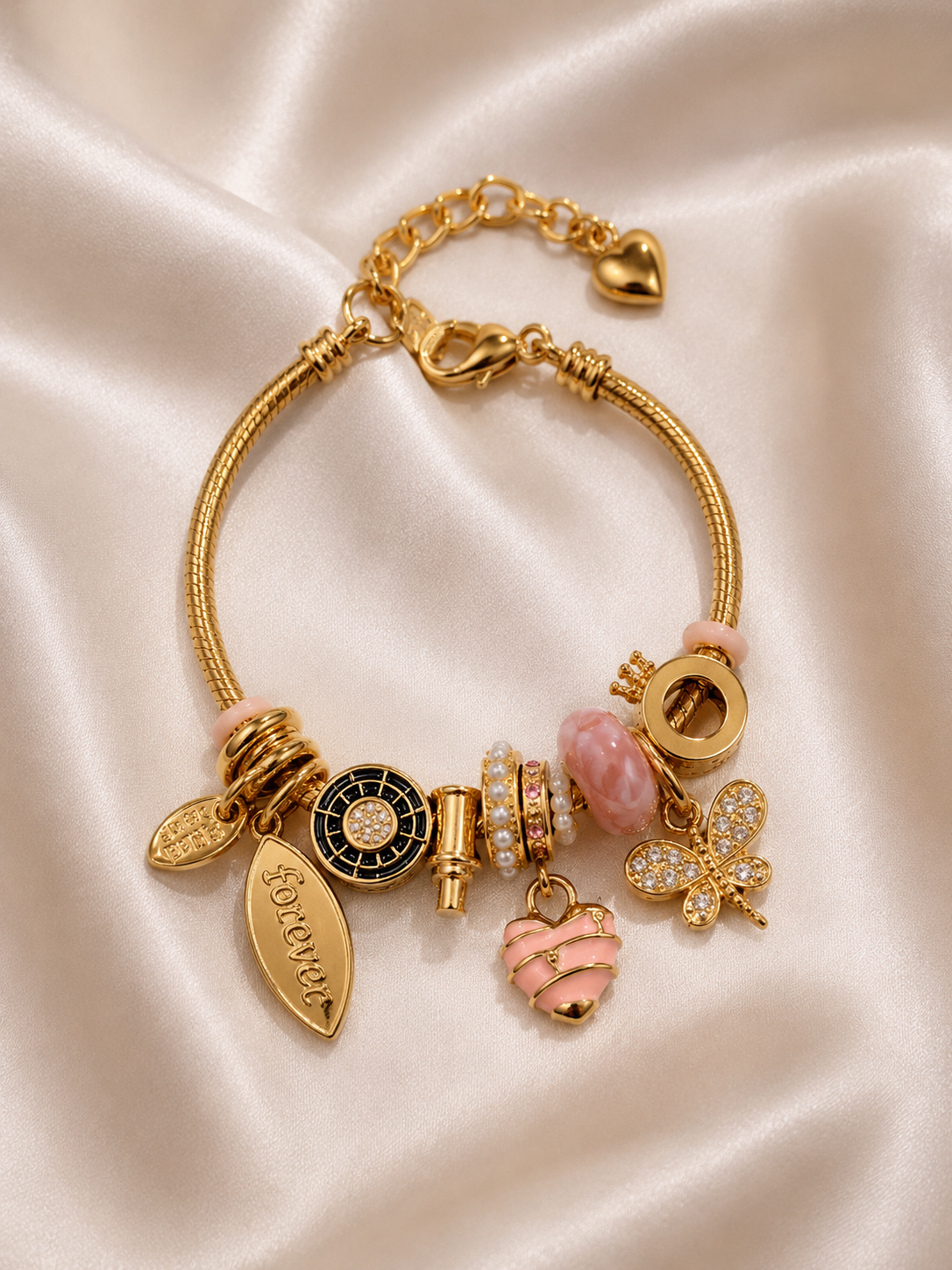 charm bracelet, pink charm bracelet, heart charm bracelet, butterfly charm bracelet, gold charm bracelet for women, anti tarnish jewellery, 316L stainless steel jewellery, lightweight bracelet, skin friendly jewellery, adjustable bracelet, everyday bracelet, demi fine jewellery, comfort jewellery, luxury charm bracelet, Ashaarya charm bracelet