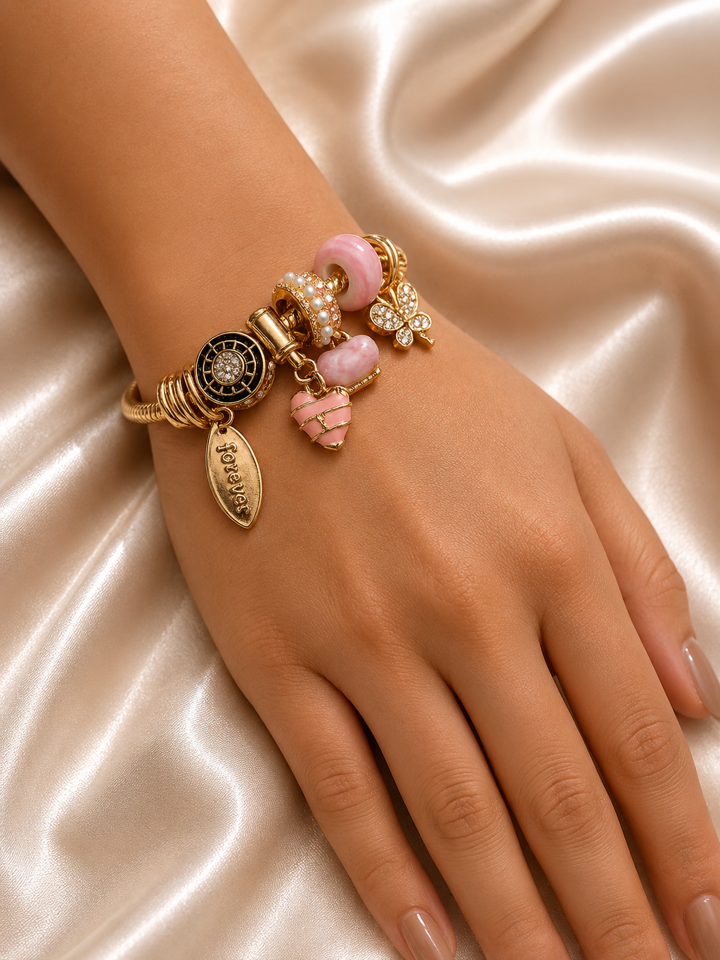 Blush Forever Charm Bracelet by Ashaarya featuring pink heart charm and 18KT gold tone finish. charm bracelet, pink charm bracelet, heart charm bracelet, butterfly charm bracelet, gold charm bracelet for women, anti tarnish jewellery, 316L stainless steel jewellery, lightweight bracelet, skin friendly jewellery, adjustable bracelet, everyday bracelet, demi fine jewellery, comfort jewellery, luxury charm bracelet, Ashaarya charm bracelet