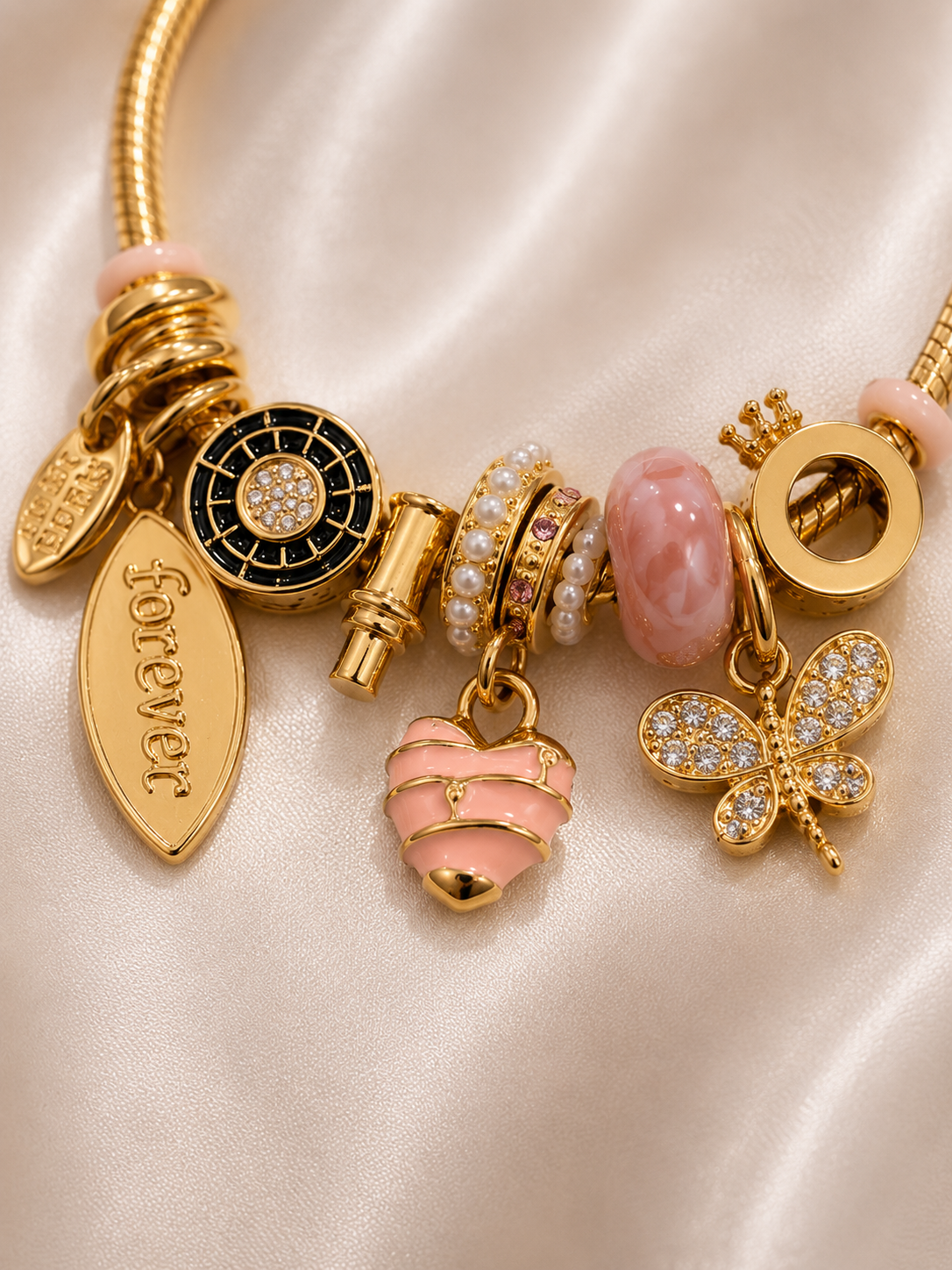 Detailed view of Blush Forever Charm Bracelet by Ashaarya, lightweight anti-tarnish comfort jewellery. charm bracelet, pink charm bracelet, heart charm bracelet, butterfly charm bracelet, gold charm bracelet for women, anti tarnish jewellery, 316L stainless steel jewellery, lightweight bracelet, skin friendly jewellery, adjustable bracelet, everyday bracelet, demi fine jewellery, comfort jewellery, luxury charm bracelet, Ashaarya charm bracelet