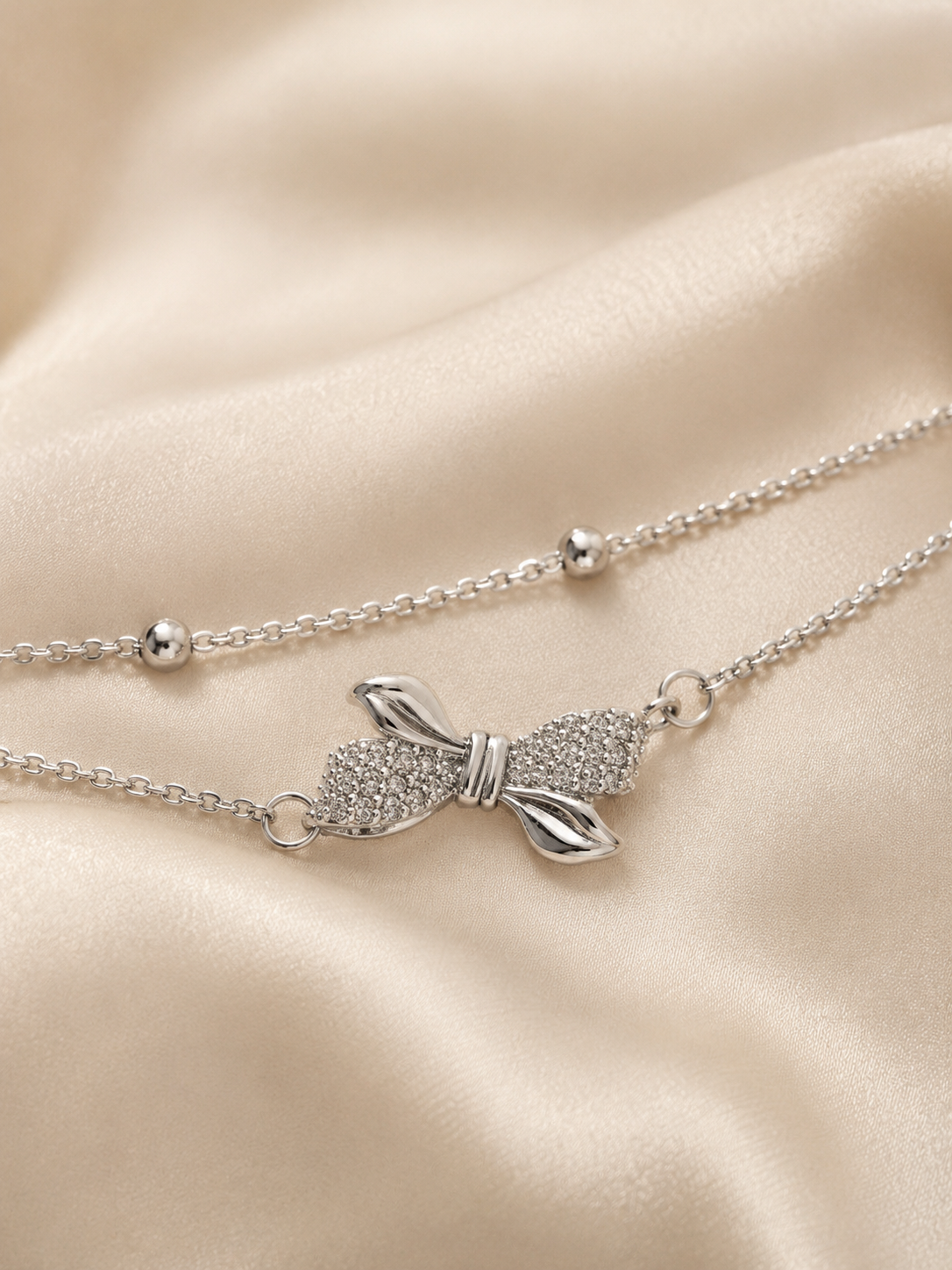 bow bracelet, bow jewellery, bow bracelet for women, anti tarnish bracelet, silver bracelet women, dainty bracelet, everyday bracelet, lightweight bracelet, adjustable bracelet, minimal bracelet, double chain bracelet, crystal bracelet, gift for girlfriend, gift for sister, office wear jewellery, comfort jewellery, stackable bracelet, skin friendly bracelet, luxury bracelet, women bracelet