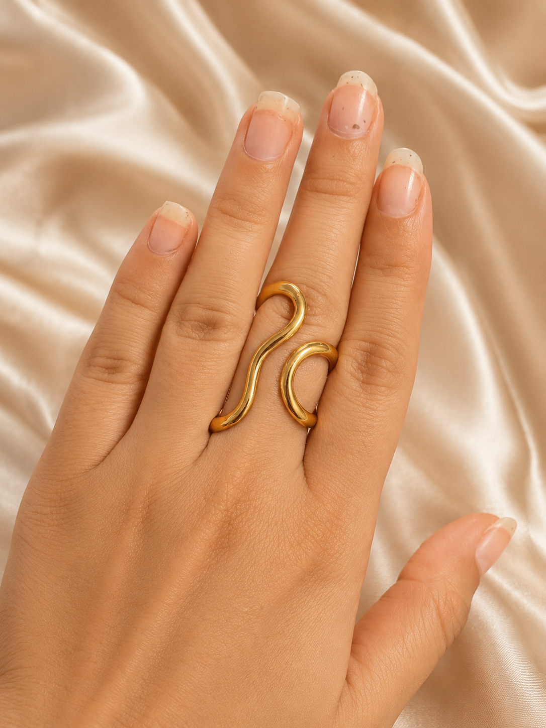 Close-up of Élan Wave Ring by Ashaarya showing sculptural wave design in 18KT gold tone