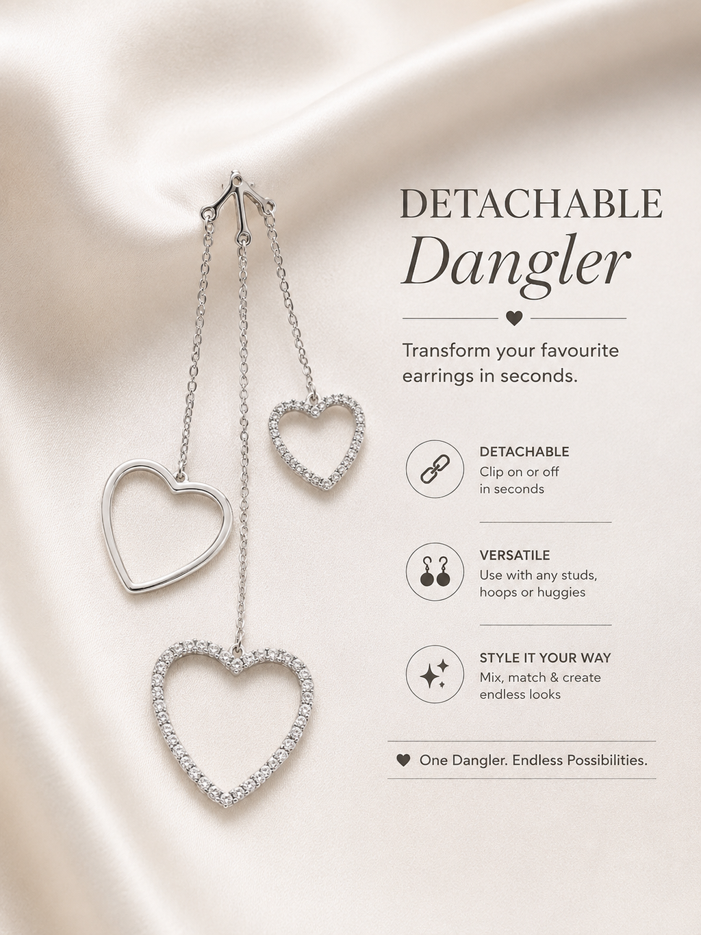 Heart-shaped detachable dangle earring on a satin surface with product details. 925 sterling silver earrings, sterling silver heart studs, silver heart earrings, 925 silver earrings for women, heart stud earrings, cubic zirconia earrings, hypoallergenic earrings, everyday silver jewellery, sterling silver studs, dainty silver earrings, silver jewellery India, Ashaarya
