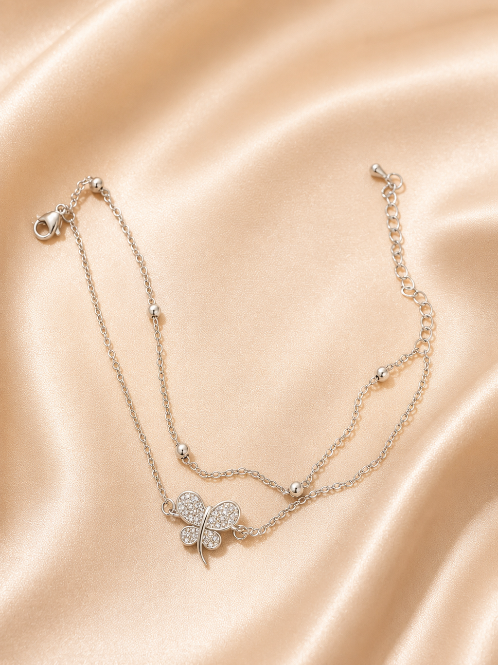The Becoming Bracelet by Ashaarya featuring a sparkling silver butterfly charm on a dual-chain anti-tarnish 316L stainless steel bracelet for women.