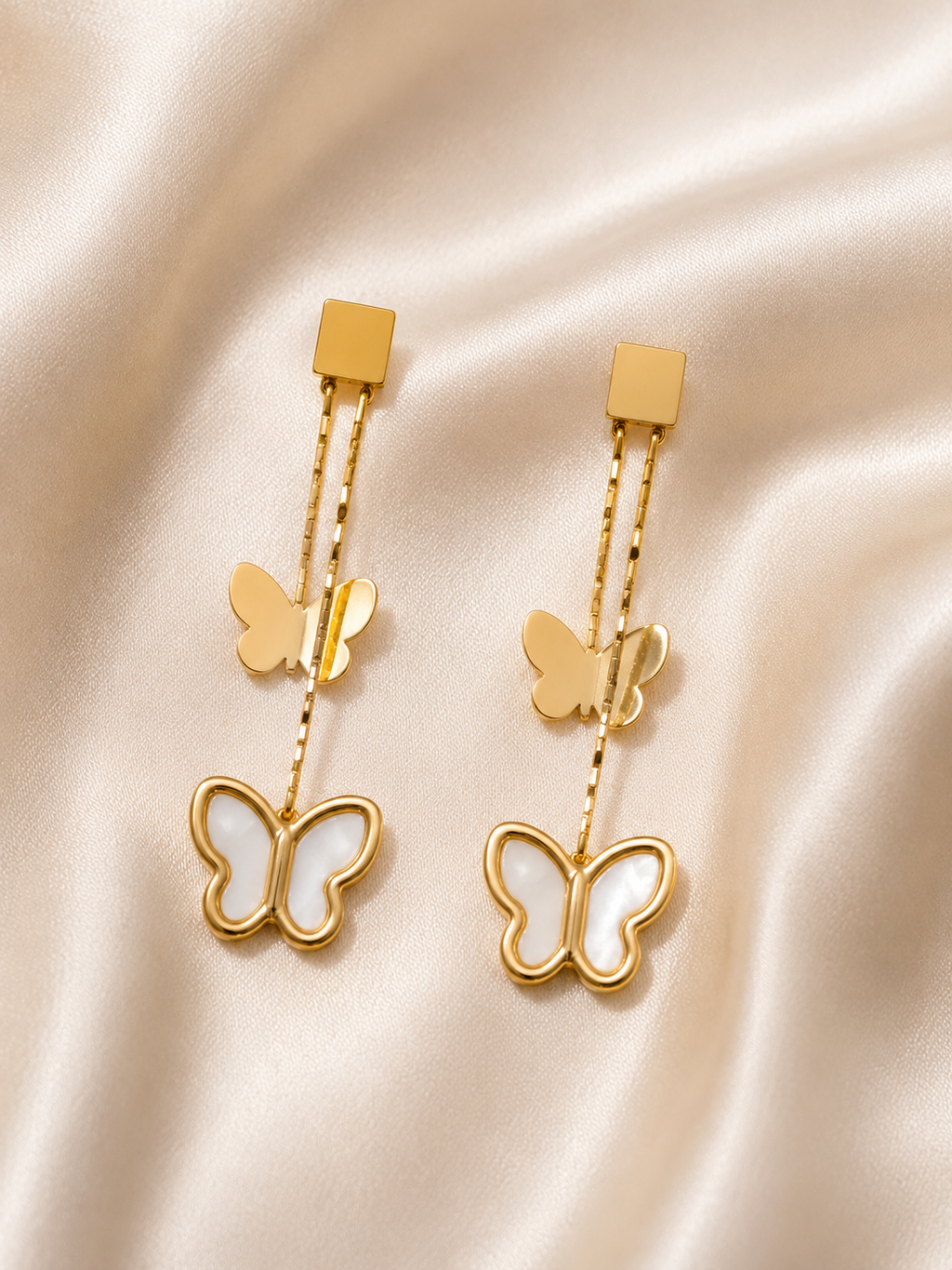 Close-up of Flutter Bloom Earrings by Ashaarya showcasing delicate butterfly detailing and premium craftsmanship.butterfly earrings for women, anti tarnish earrings, lightweight earrings, 18kt gold tone earrings, stainless steel earrings, drop earrings for women, elegant butterfly earrings, mother of pearl earrings, skin friendly jewellery, comfort jewellery, premium earrings, Ashaarya earrings