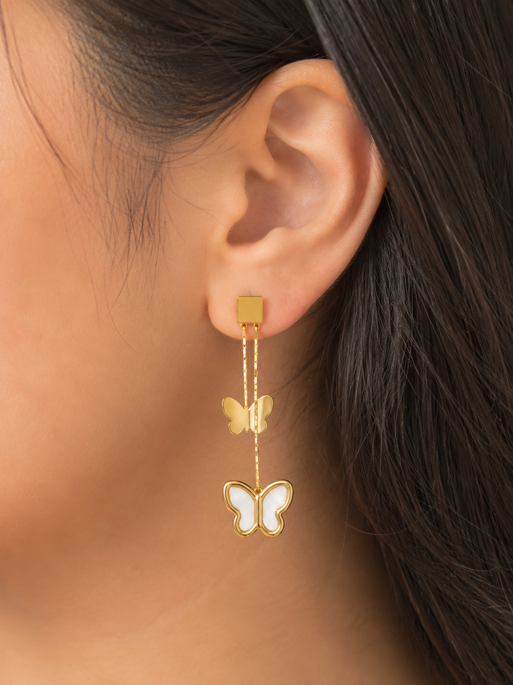 Flutter Bloom Earrings by Ashaarya featuring mother-of-pearl butterfly drop design in 18KT gold tone. butterfly earrings for women, anti tarnish earrings, lightweight earrings, 18kt gold tone earrings, stainless steel earrings, drop earrings for women, elegant butterfly earrings, mother of pearl earrings, skin friendly jewellery, comfort jewellery, premium earrings, Ashaarya earrings