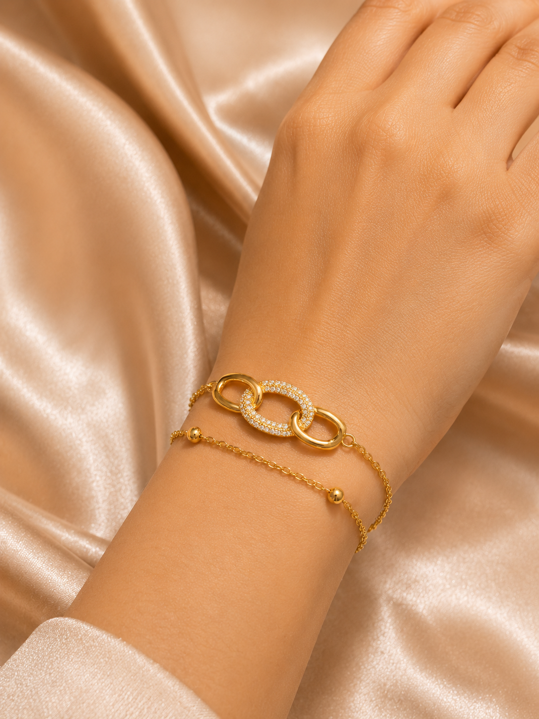 Interlink Dual Chain Bracelet by Ashaarya featuring a crystal-studded interlocking link in 18KT gold plated 316L stainless steel. Lightweight, anti-tarnish bracelet for women.